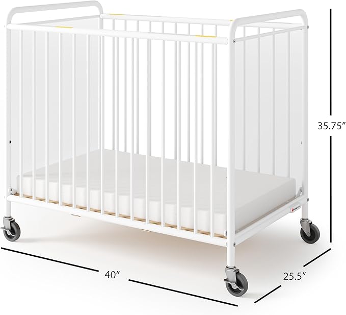Foundations Chelsea Clearview Metal Compact Daycare Crib, 3" Casters, Compact Mini Size, Easy to Clean Durable Finish, Adjustable to Two Heights Mattress Board (White)